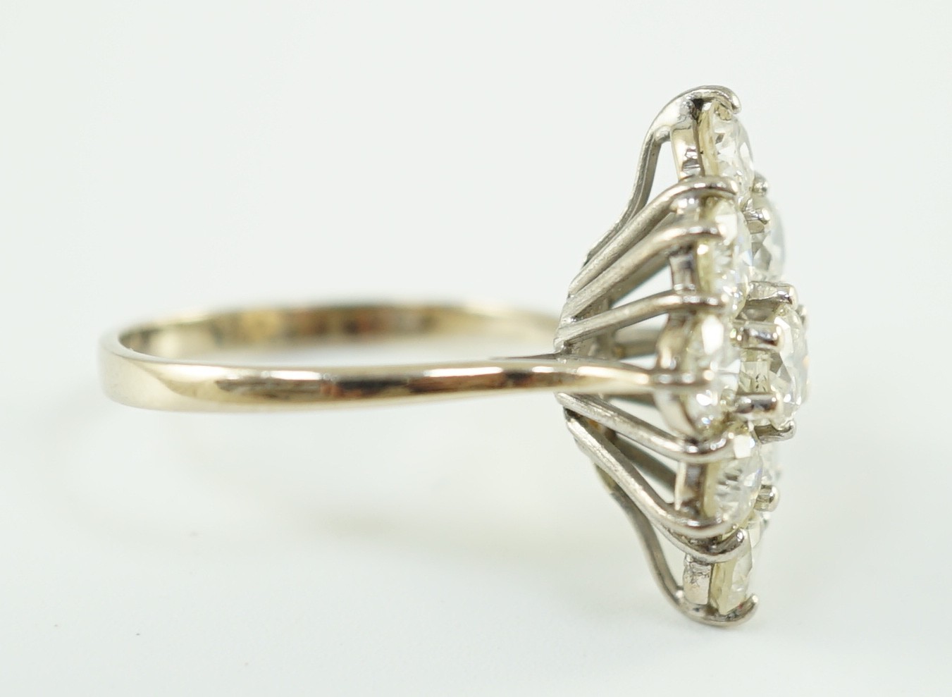 An 18ct white gold and nine stone diamond cluster set marquise shaped diamond ring